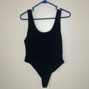 Woman’s black ribbed body suit